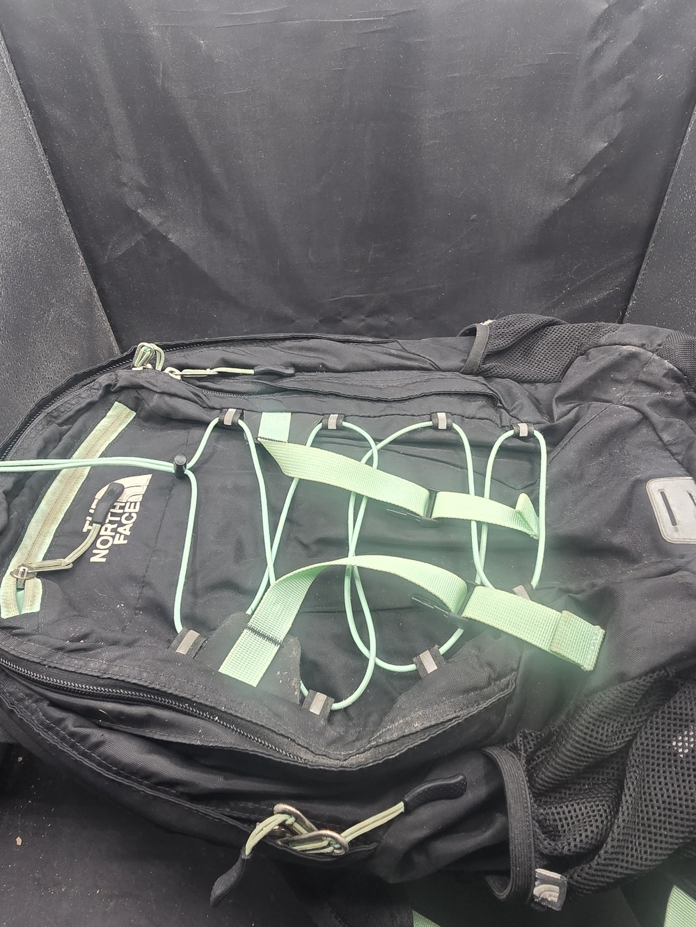 The North Face Black Backpack with Mint Green Bungee and Straps